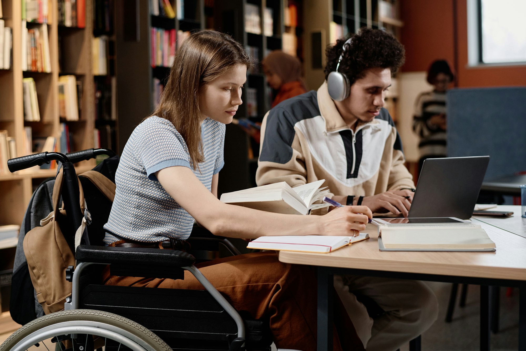 Student With Disability And Her Friend At Library